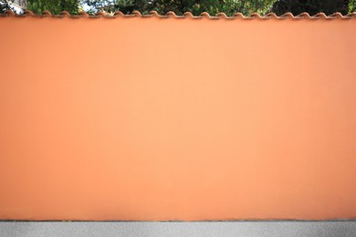 Beautiful orange wall and concrete sidewalk outdoors