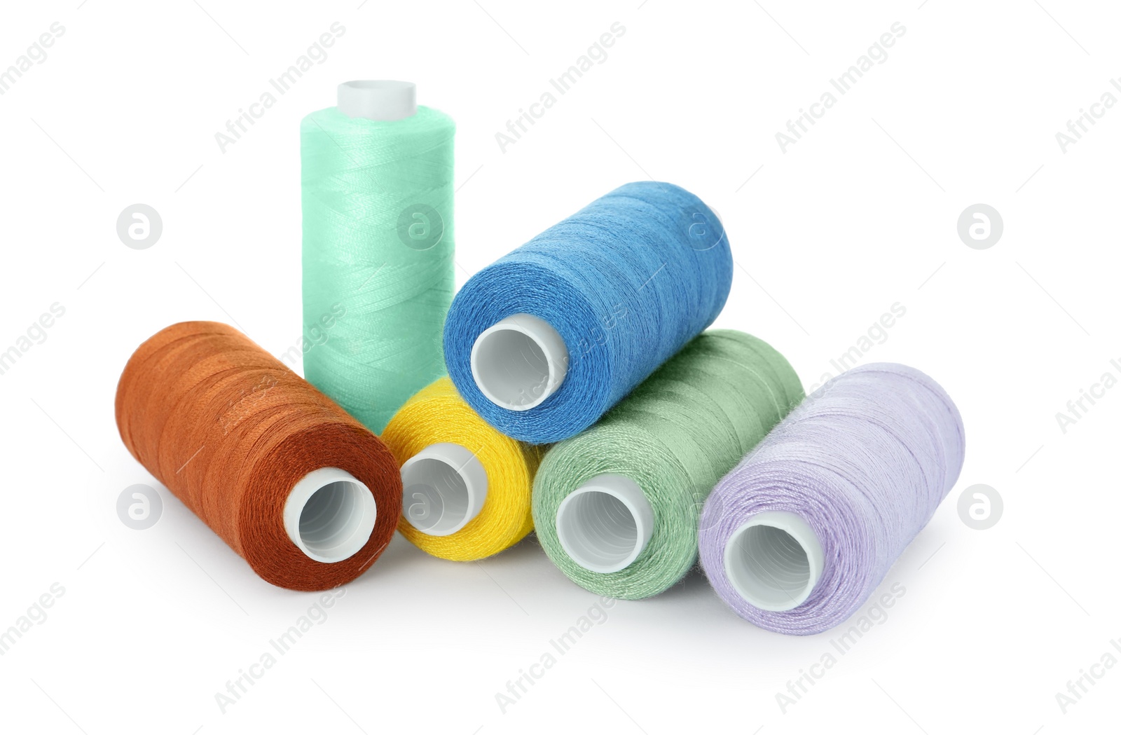 Photo of Set of different colorful sewing threads on white background