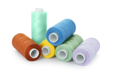 Photo of Set of different colorful sewing threads on white background