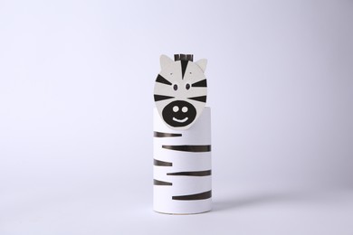 Toy zebra made from toilet paper hub on white background. Children's handmade ideas