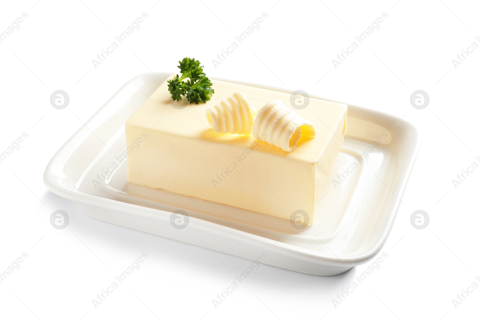 Photo of Ceramic dish with block of fresh butter on white background