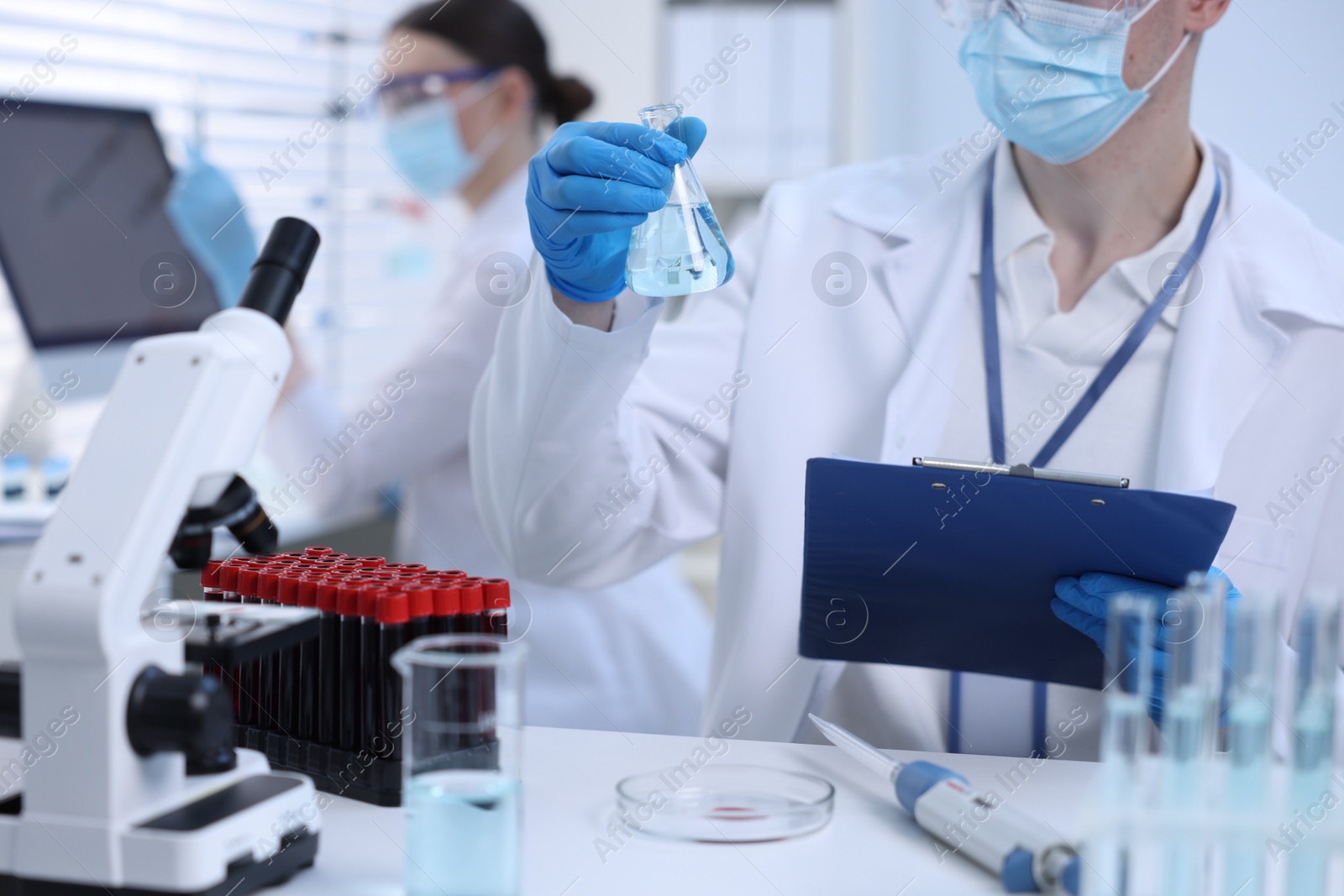 Photo of Scientists working with samples in laboratory, closeup. Medical research