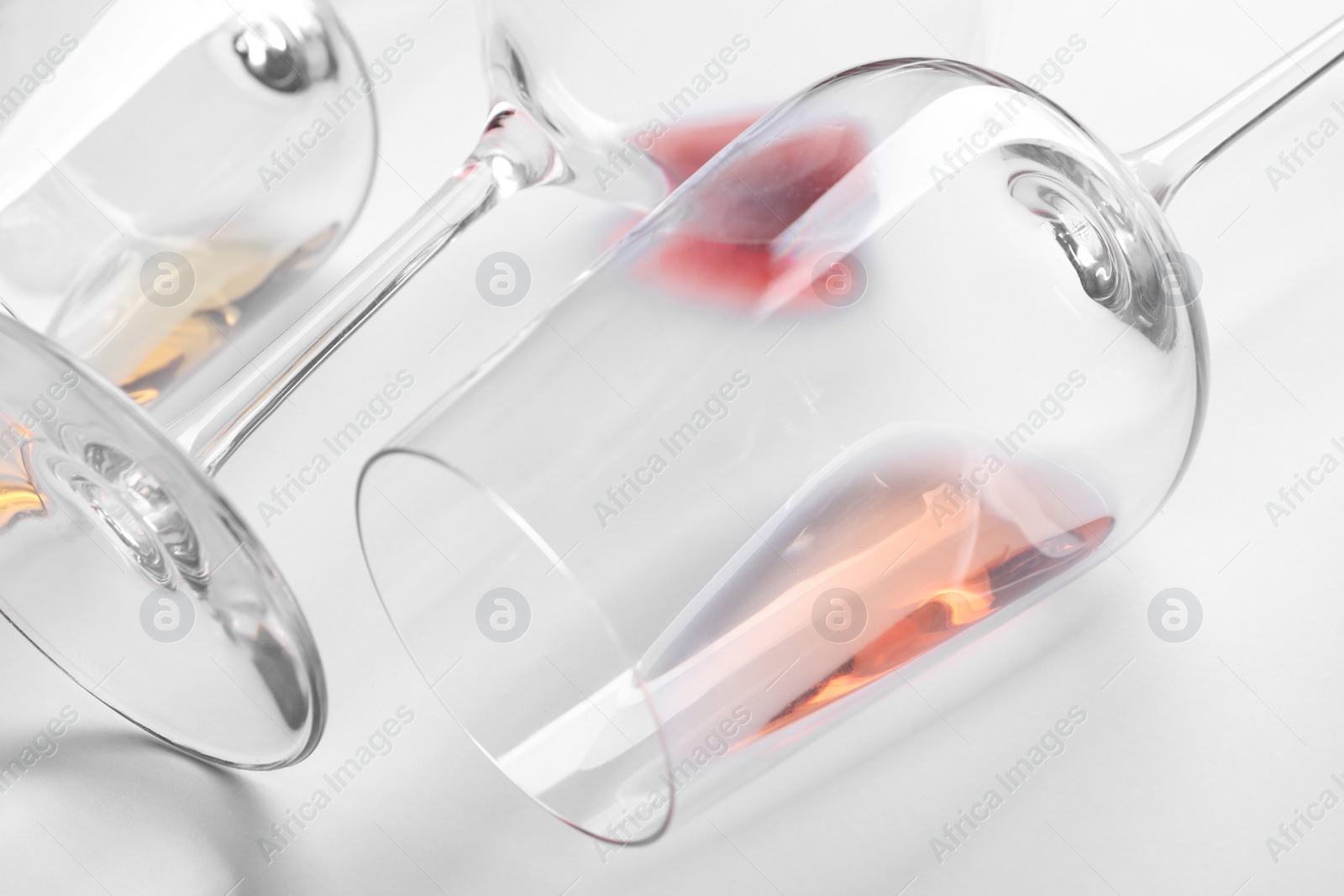 Photo of Glasses with wine on white background, closeup