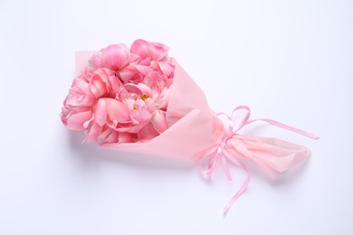 Beautiful bouquet of pink peonies on white background, top view