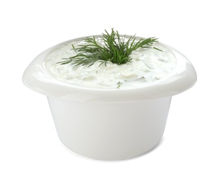 Photo of Bowl with cucumber sauce on white background