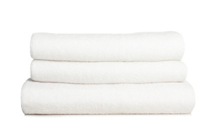 Photo of Folded soft terry towels on white background