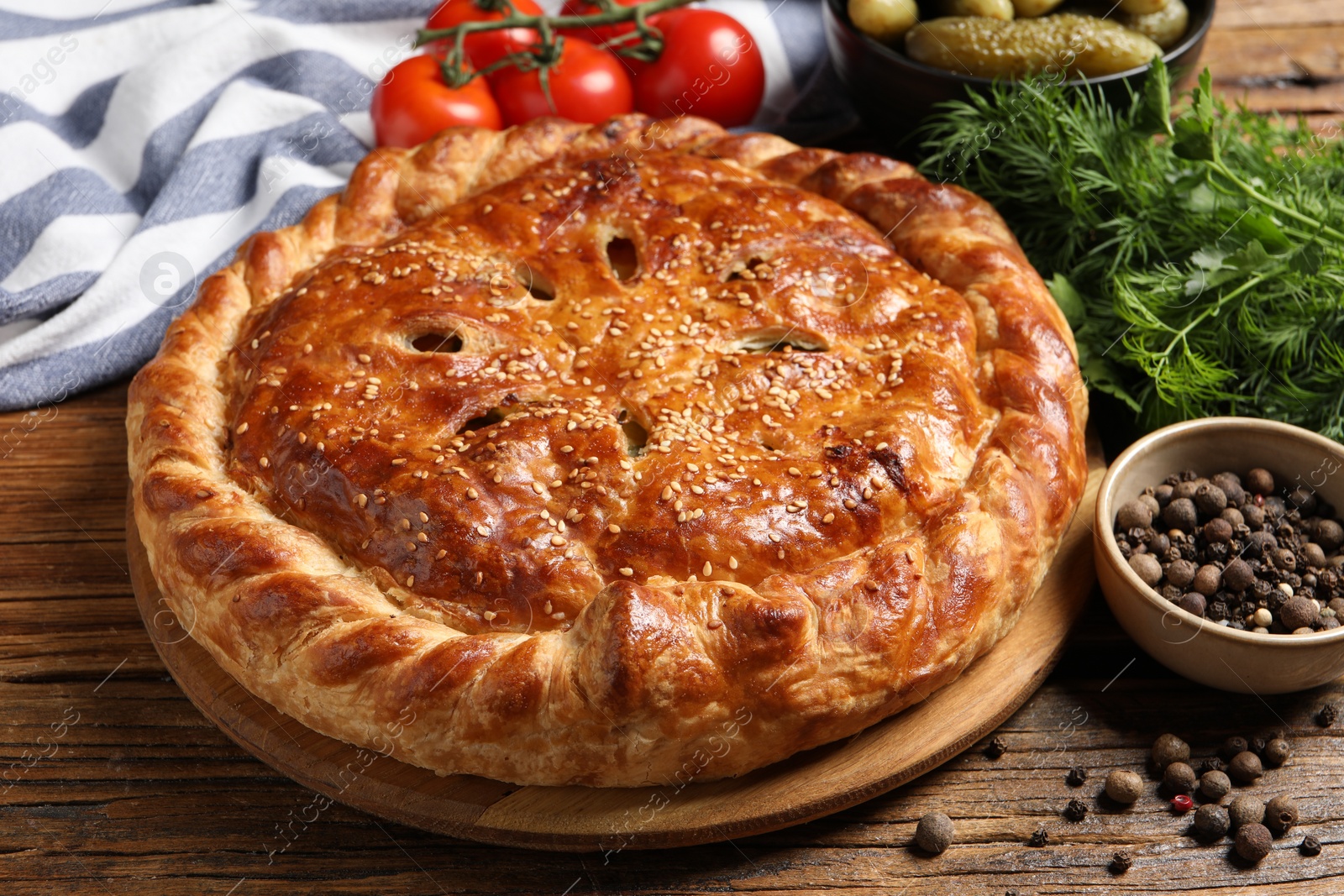 Photo of Tasty homemade pie and ingredients on wooden table