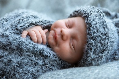 Photo of Cute newborn baby sleeping on blanket, closeup