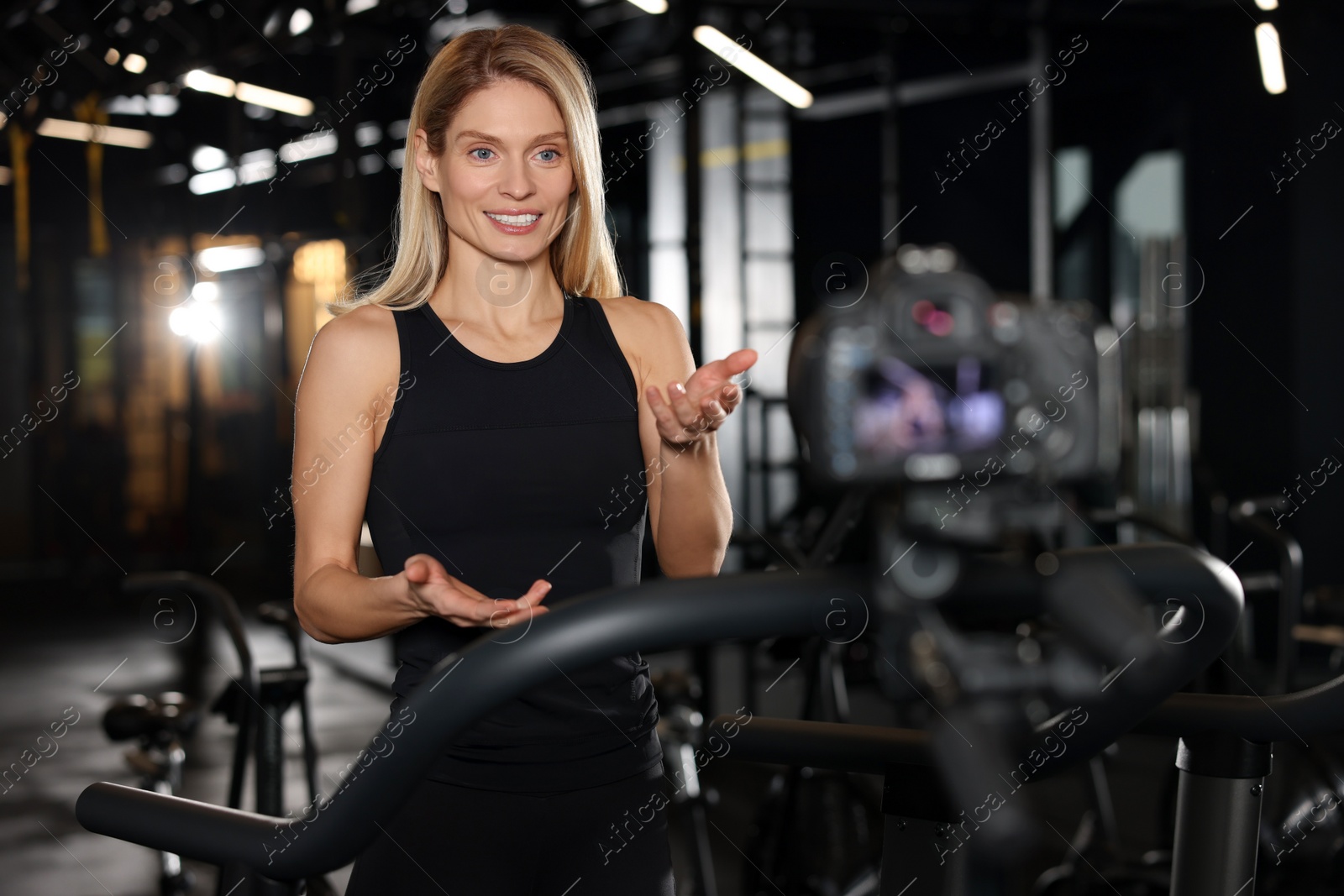 Photo of Fitness trainer recording online classes in gym