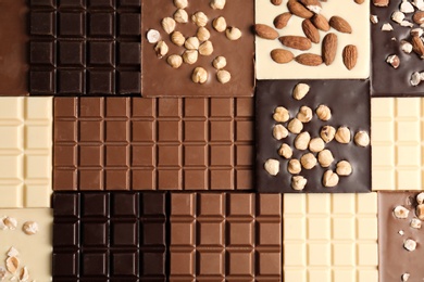 Photo of Many different delicious chocolate bars as background