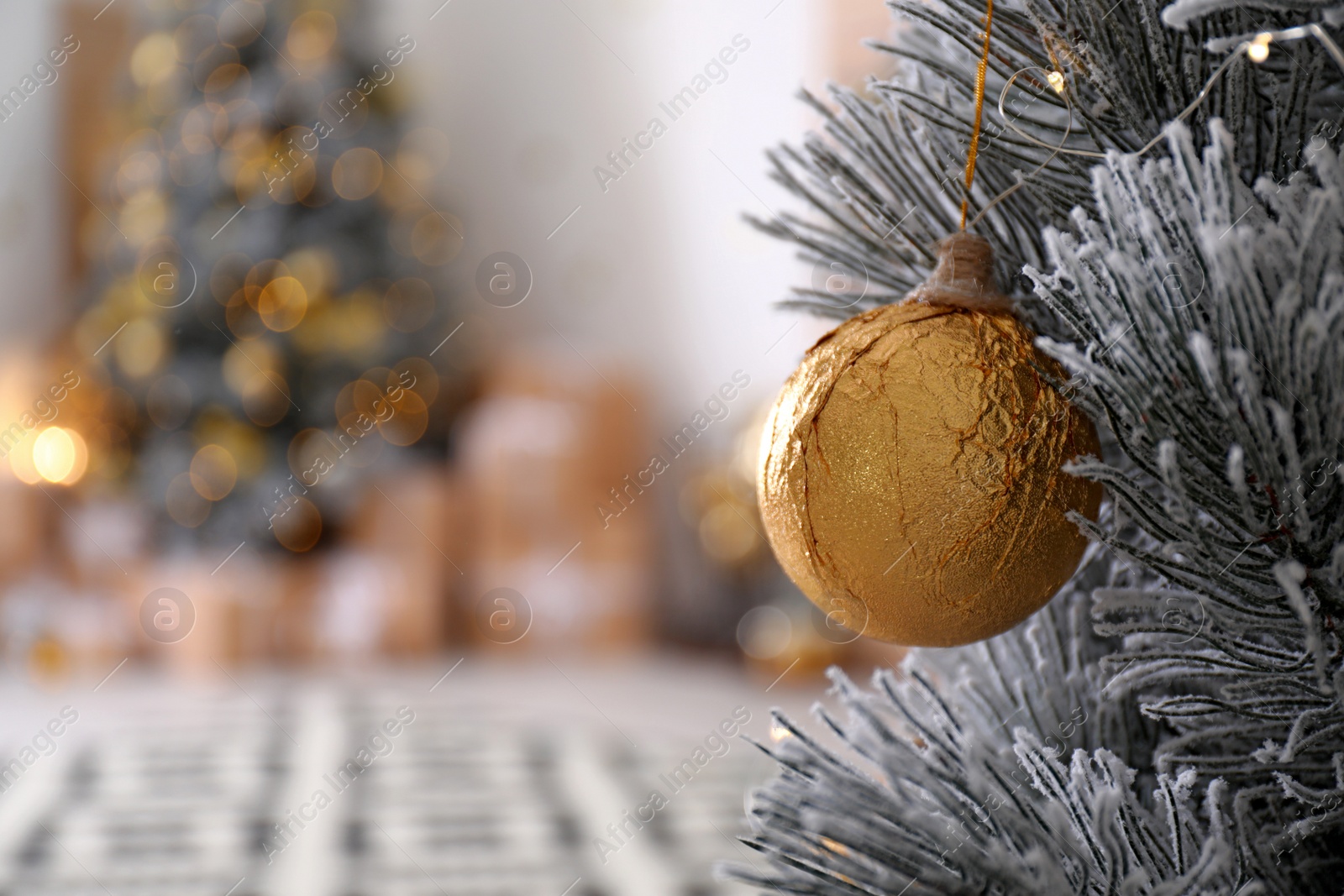 Photo of Beautiful Christmas tree decorated with ball in stylish room interior, closeup. Space for text