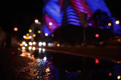 Photo of Viewcityscape with bokeh effect, focus on asphalt. Night life