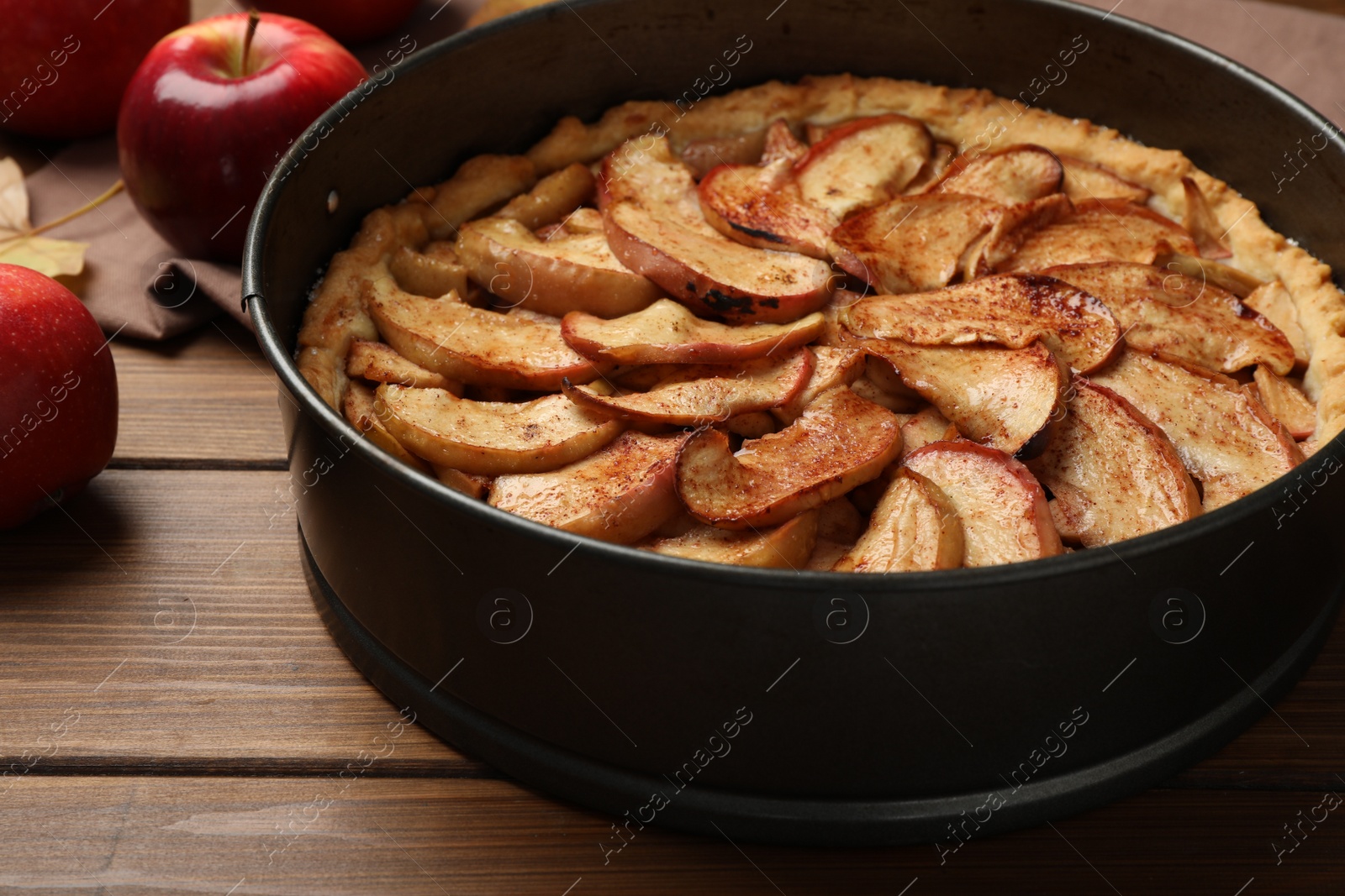 Photo of Delicious apple pie and fresh fruits on wooden table, closeup