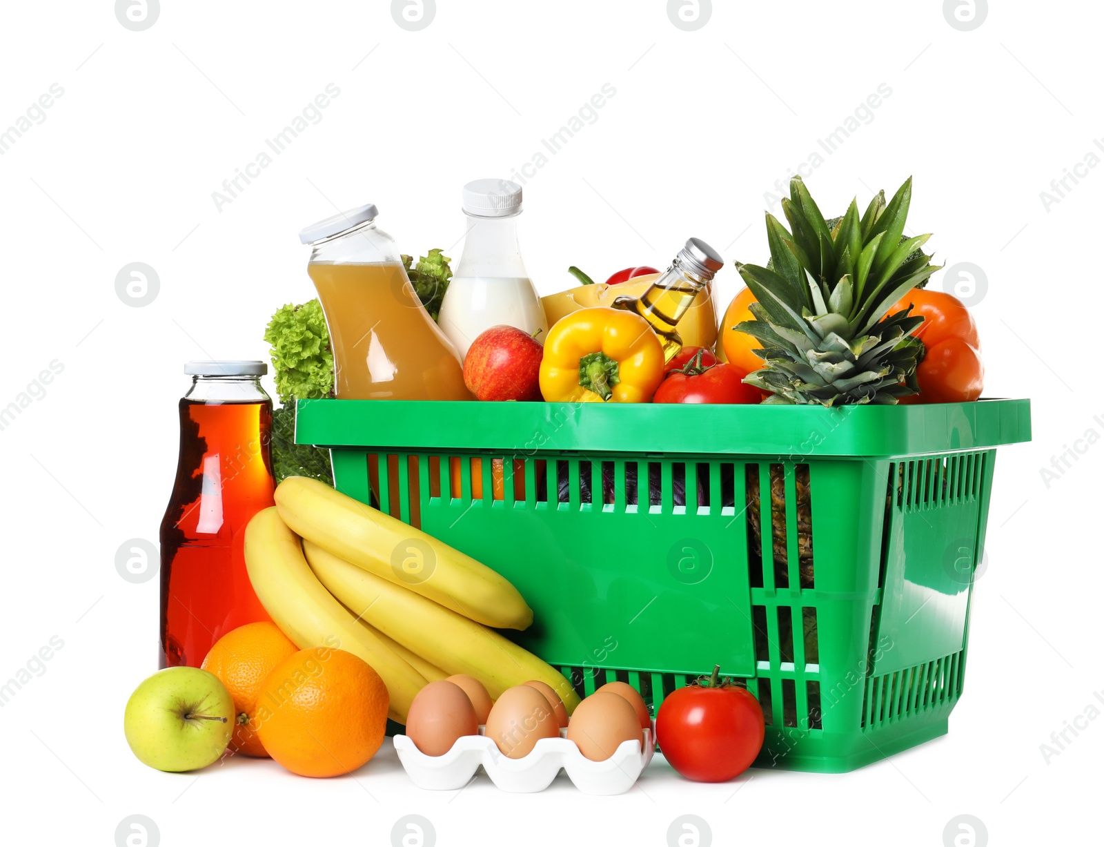 Photo of Shopping basket and grocery products on white background