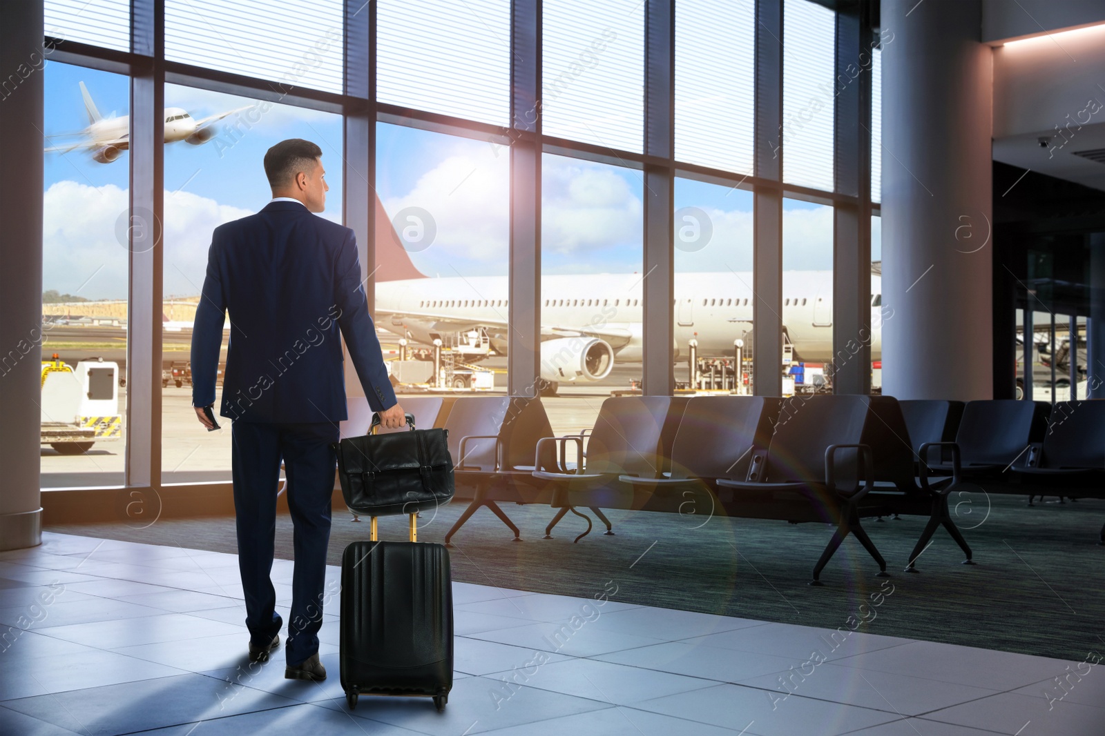 Image of Businessman with bag and travel suitcase at airport terminal. Summer vacation