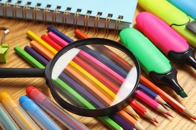 Photo of Different stationery on wooden table. Back to school