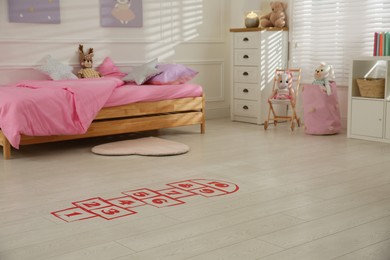 Red hopscotch floor sticker in bedroom at home