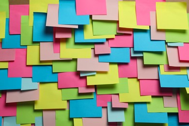 Photo of Colorful paper notes as background, closeup view
