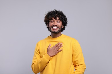 Photo of Handsome smiling man on light grey background