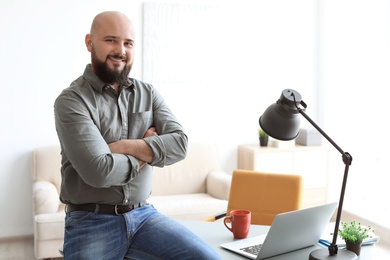 Portrait of confident young man in room