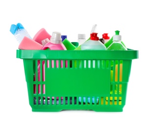 Green shopping basket with different household chemicals on white background