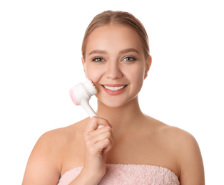 Photo of Young woman washing face with cleansing brush on white background. Cosmetic product