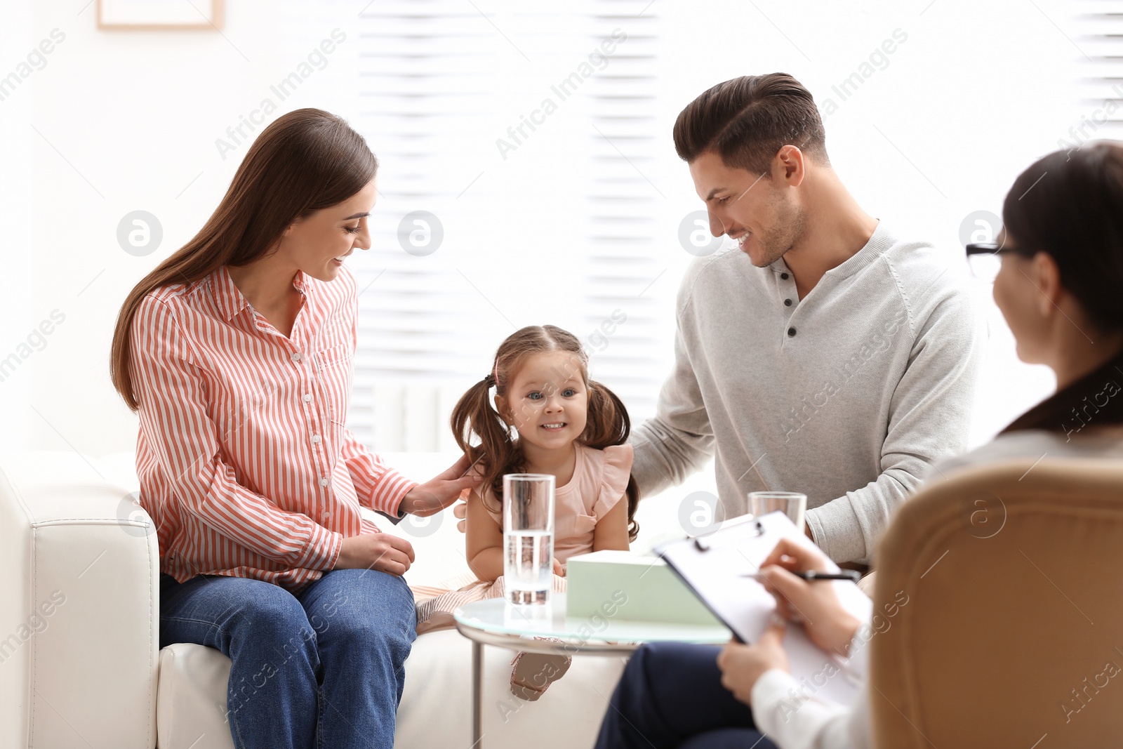 Photo of Professional psychologist working with family in office