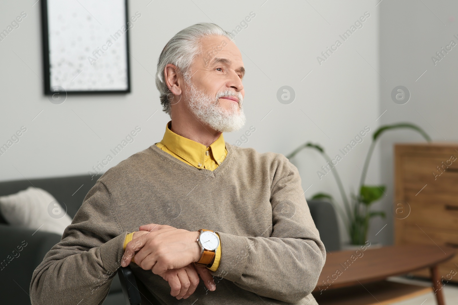 Photo of Portrait of handsome senior man at home