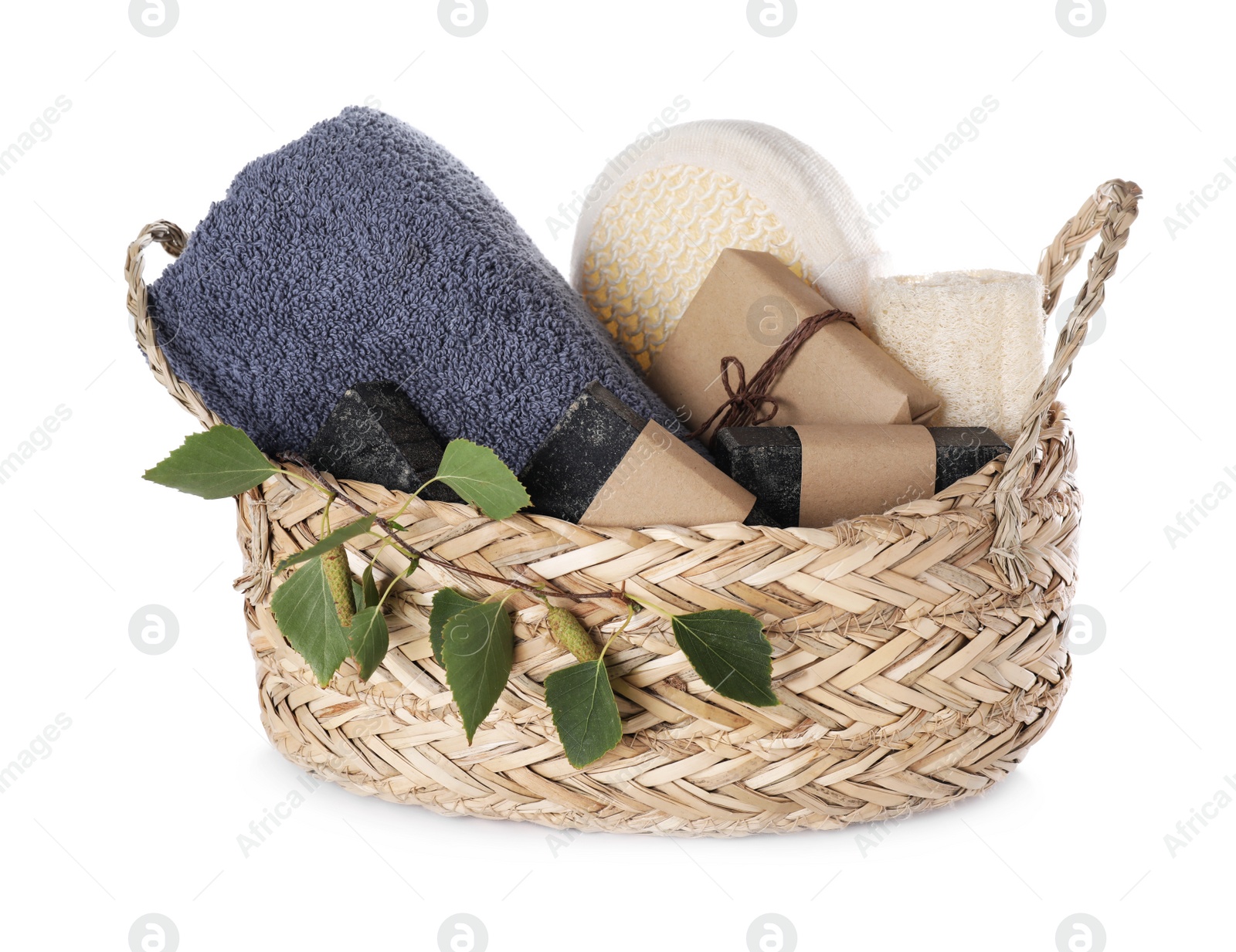 Photo of Natural tar soap in wicker basket on white background