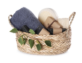 Photo of Natural tar soap in wicker basket on white background