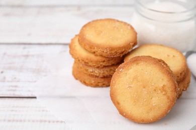 Photo of Tasty sweet sugar cookies on white wooden table, closeup. Space for text