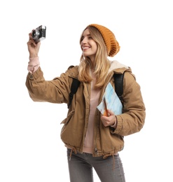 Woman with map and backpack taking picture on white background. Winter travel