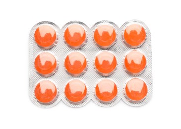 Blister with orange cough drops on white background, top view