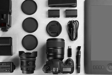 Photo of Flat lay composition with equipment for professional photographer on grey marble table