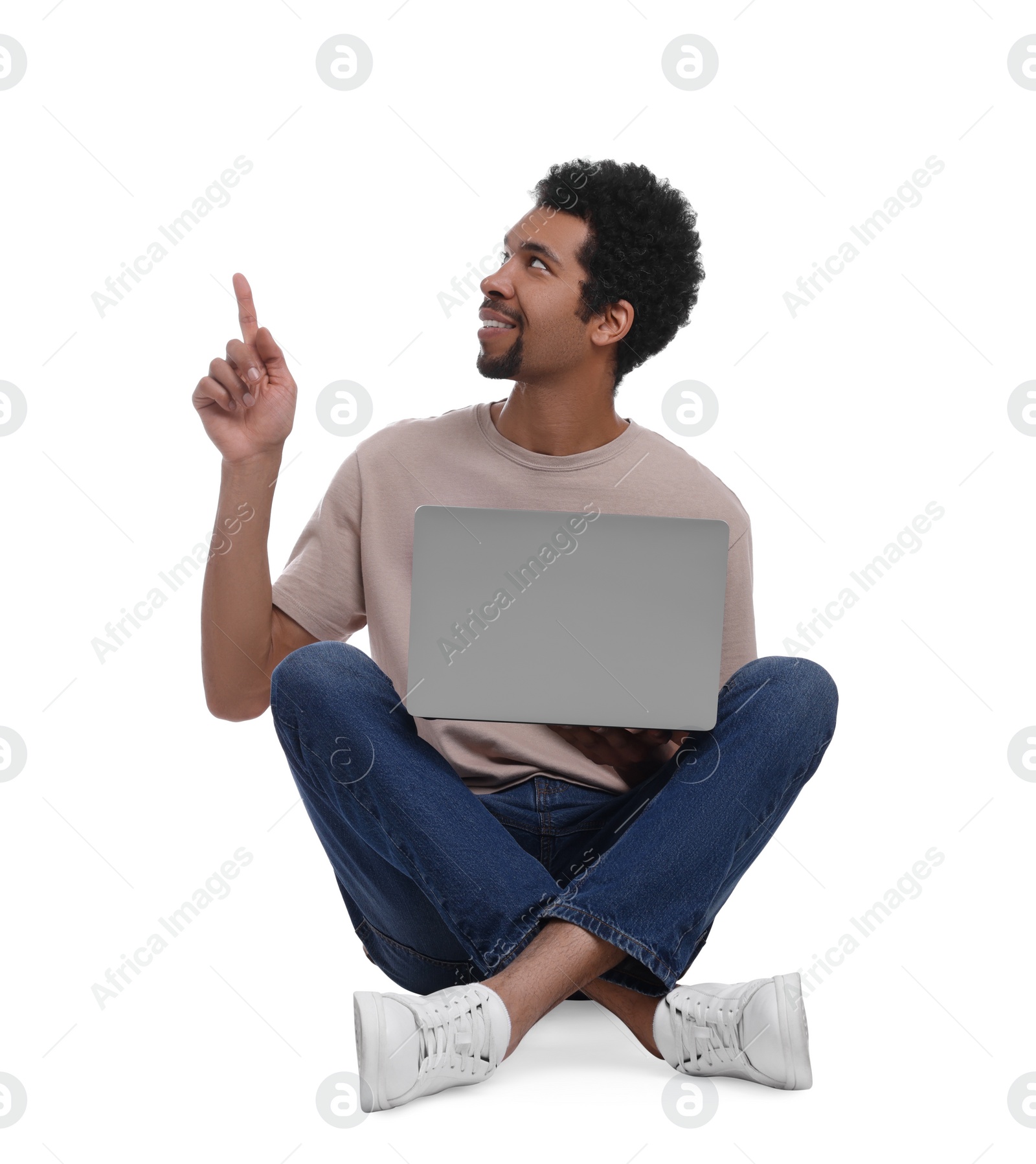 Photo of Smiling man with laptop pointing at something on white background