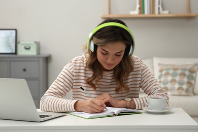 Online test. Woman studying with laptop at home