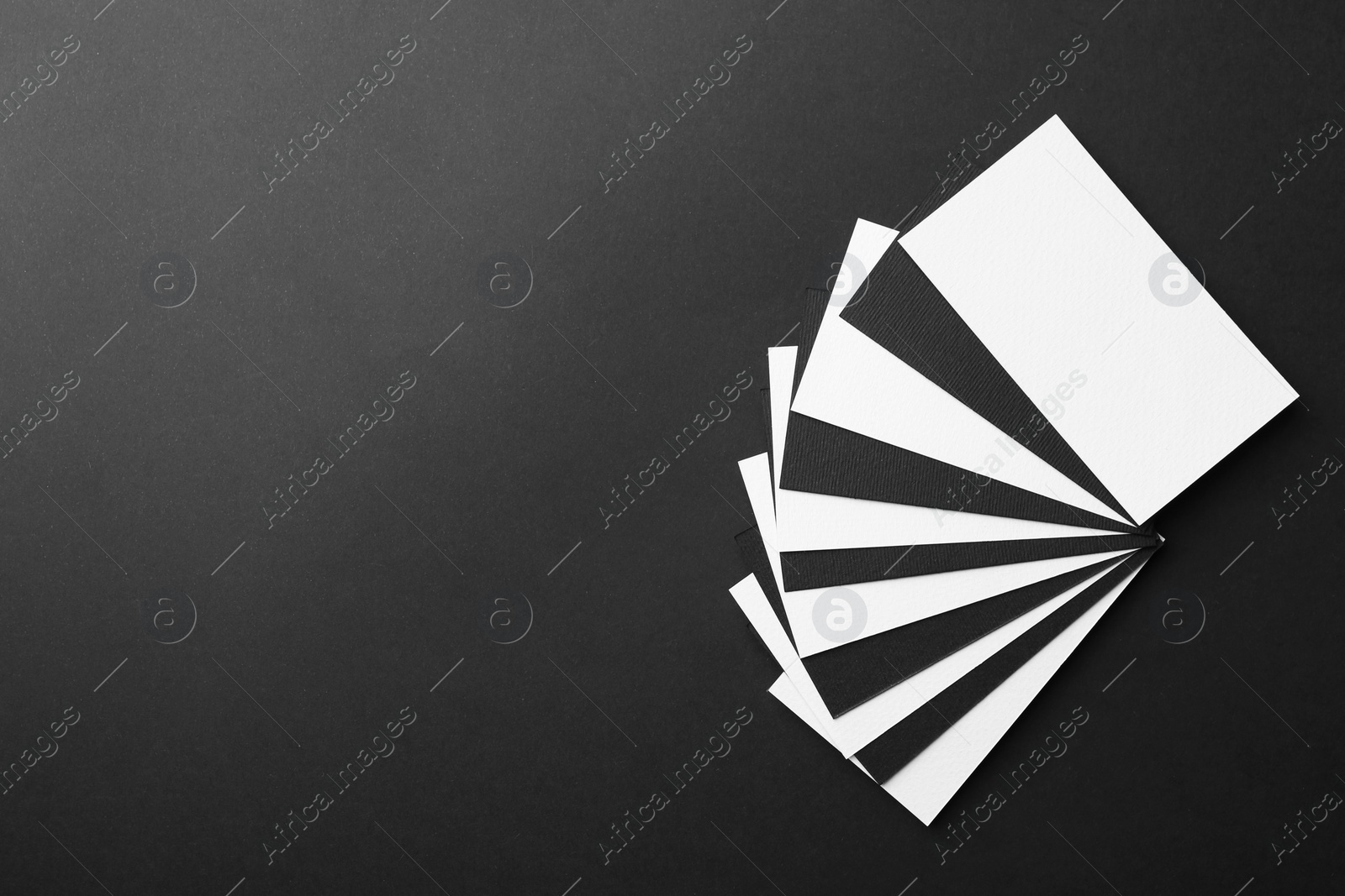 Photo of Blank business cards on black background, top view. Mockup for design