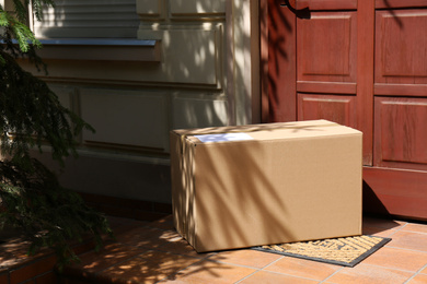 Photo of Delivered parcel on door mat near entrance