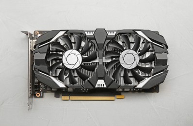 Computer graphics card on gray textured background, top view