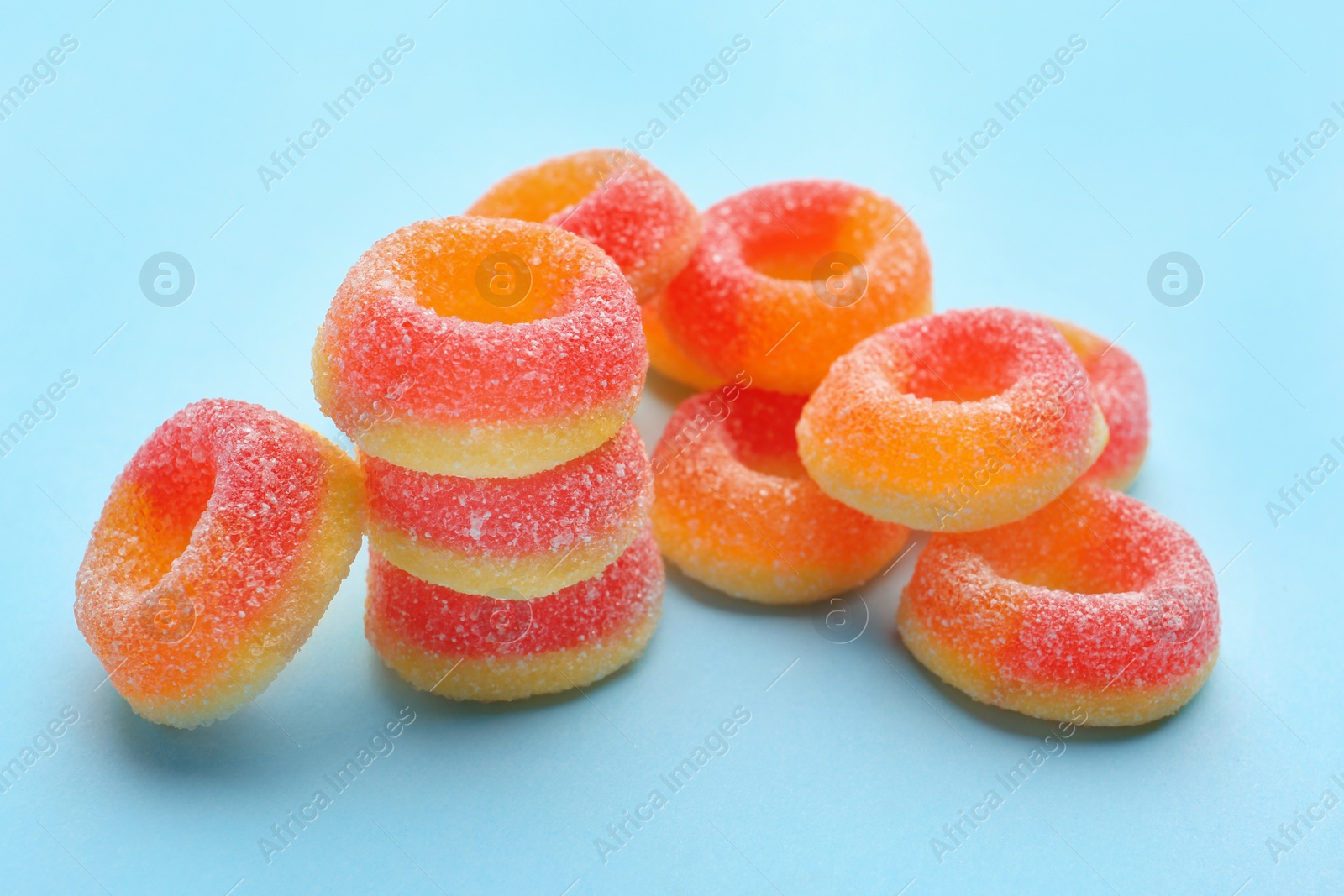 Photo of Tasty fresh jelly candies on color background, space for text