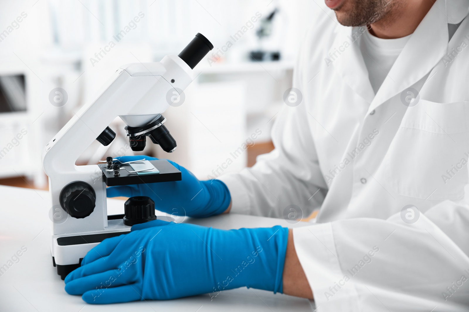 Photo of Scientist with modern microscope at table, closeup. Medical research