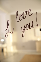 Photo of Handwritten text I Love You on mirror in room. Romantic message