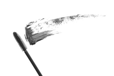 Photo of Smear of mascara and applicator isolated on white, top view