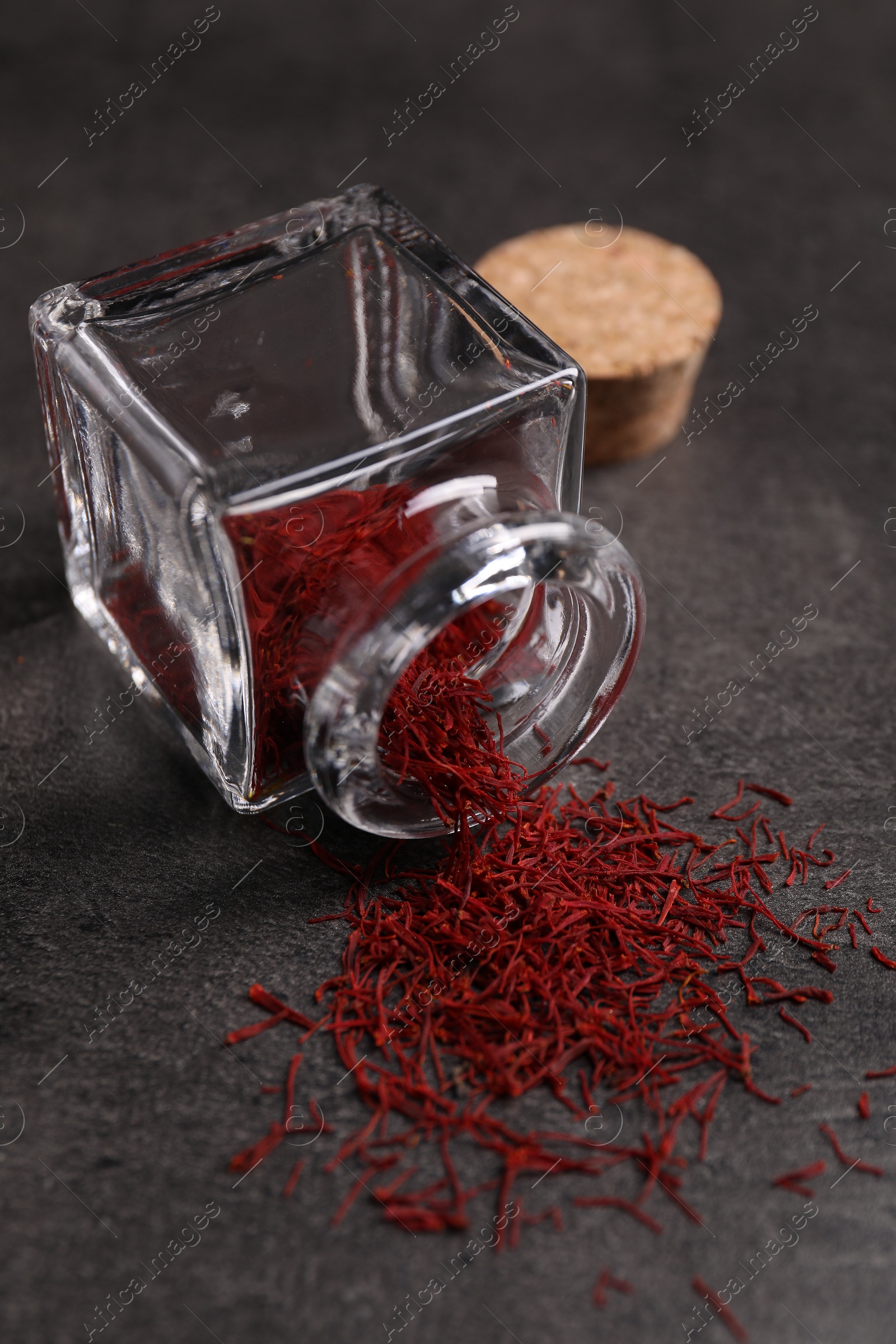 Photo of Aromatic saffron and glass jar on gray table