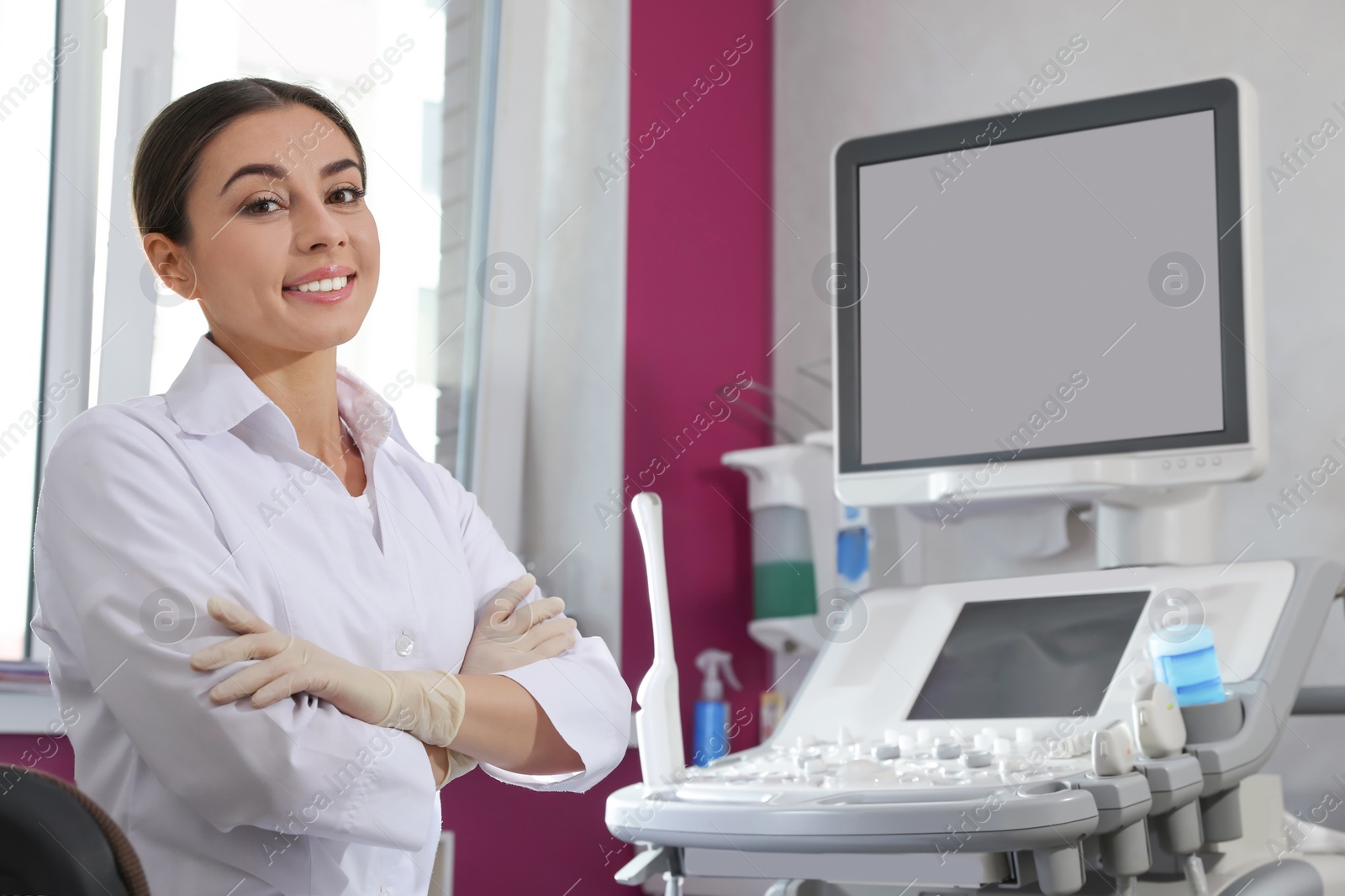 Photo of Sonographer near modern ultrasound machine in clinic, space for text