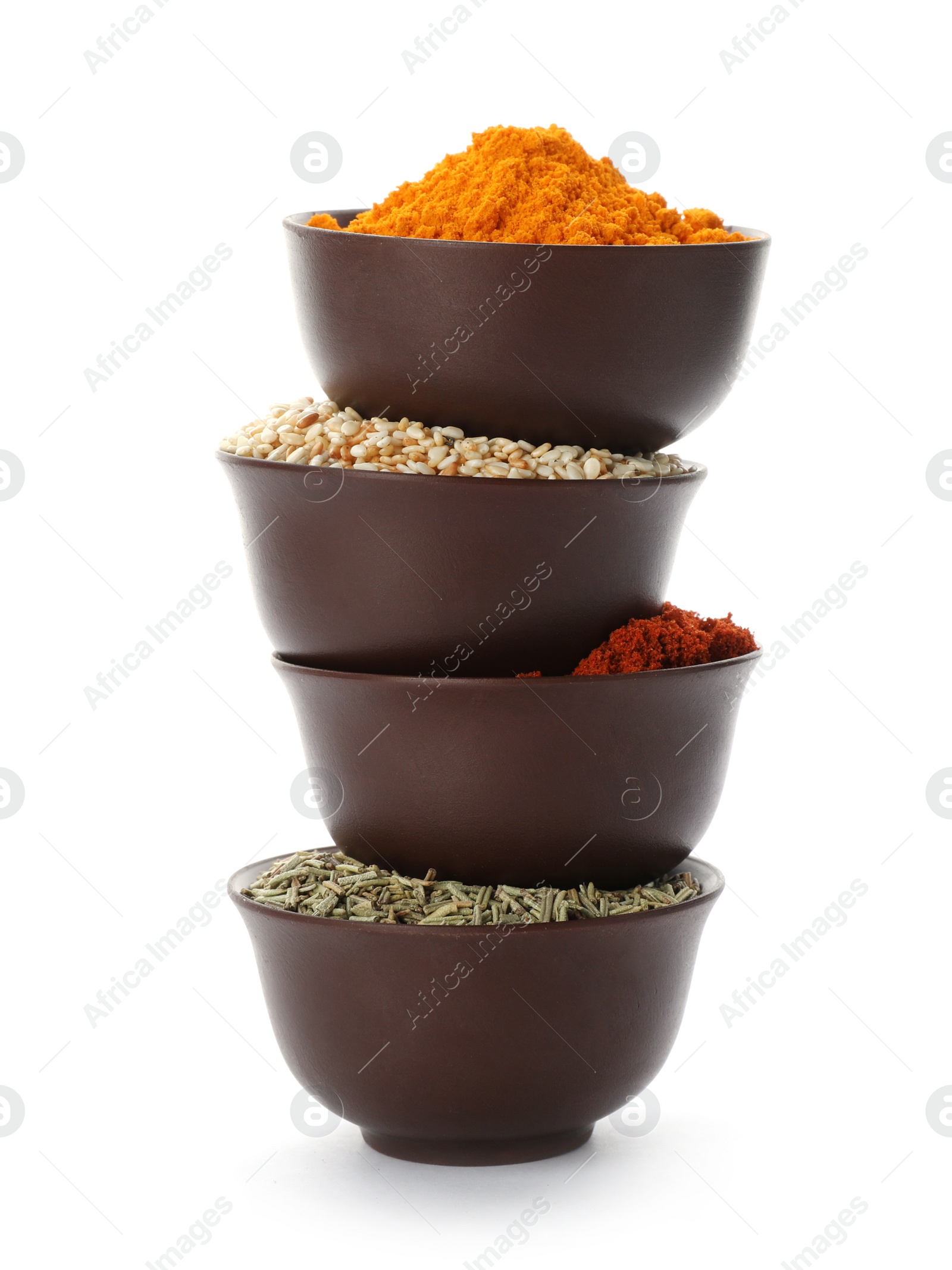 Photo of Stack of bowls with different aromatic spices on white background