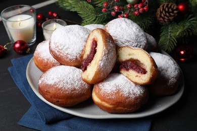 Photo of Delicious sweet buns with jam and decor on table, closeup