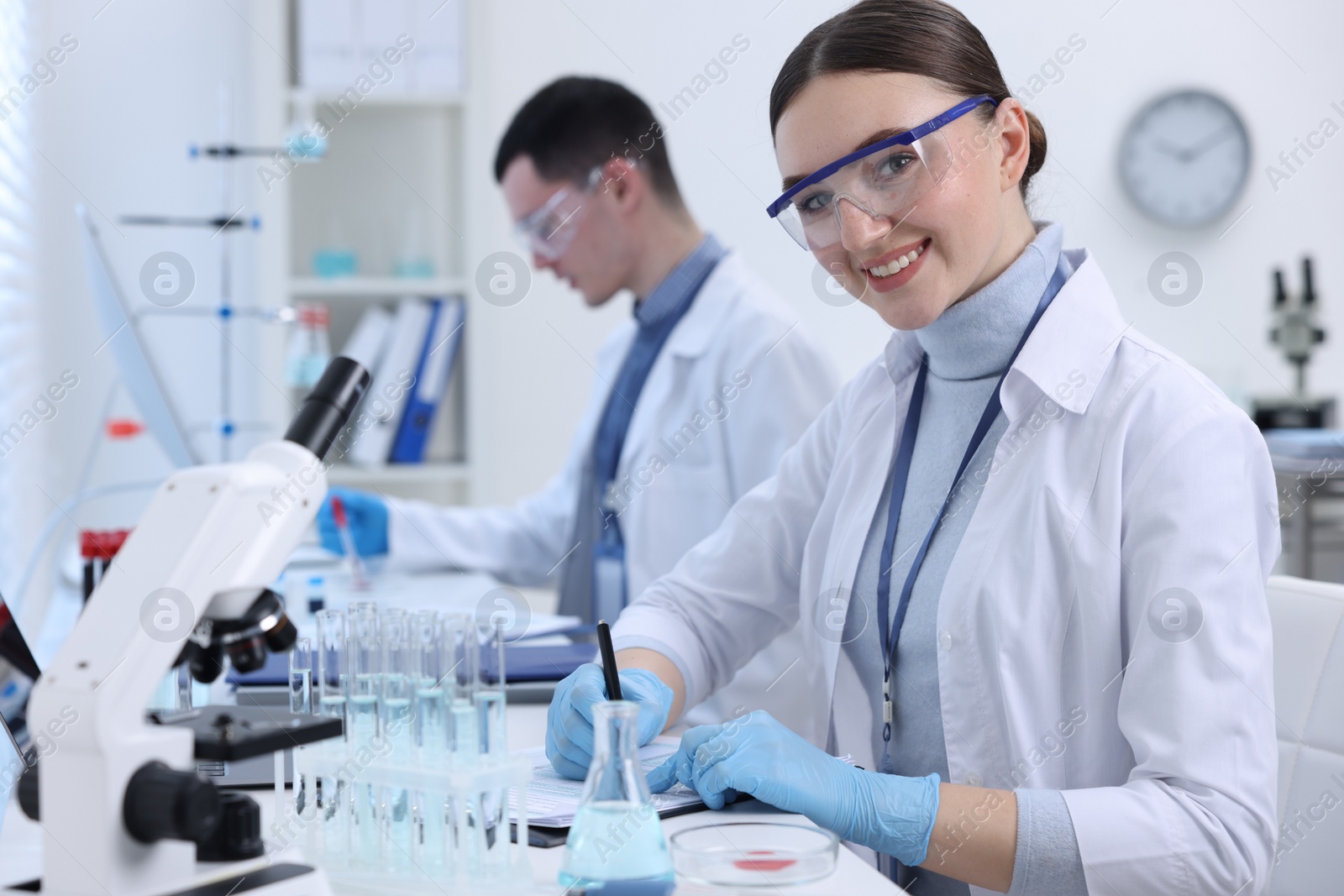 Photo of Scientists working with documents in laboratory. Medical research