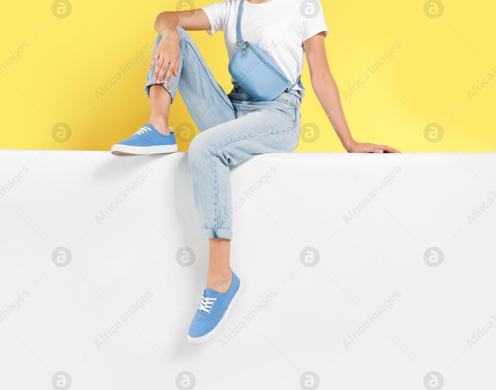 Photo of Woman wearing stylish shoes on color background, closeup