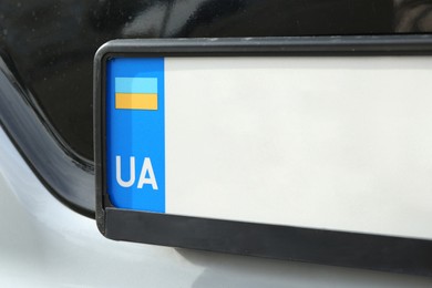 Car with vehicle registration plate, closeup view
